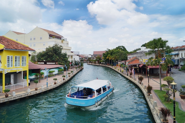 A boat going down the popular tourist attraction, the Melaka River