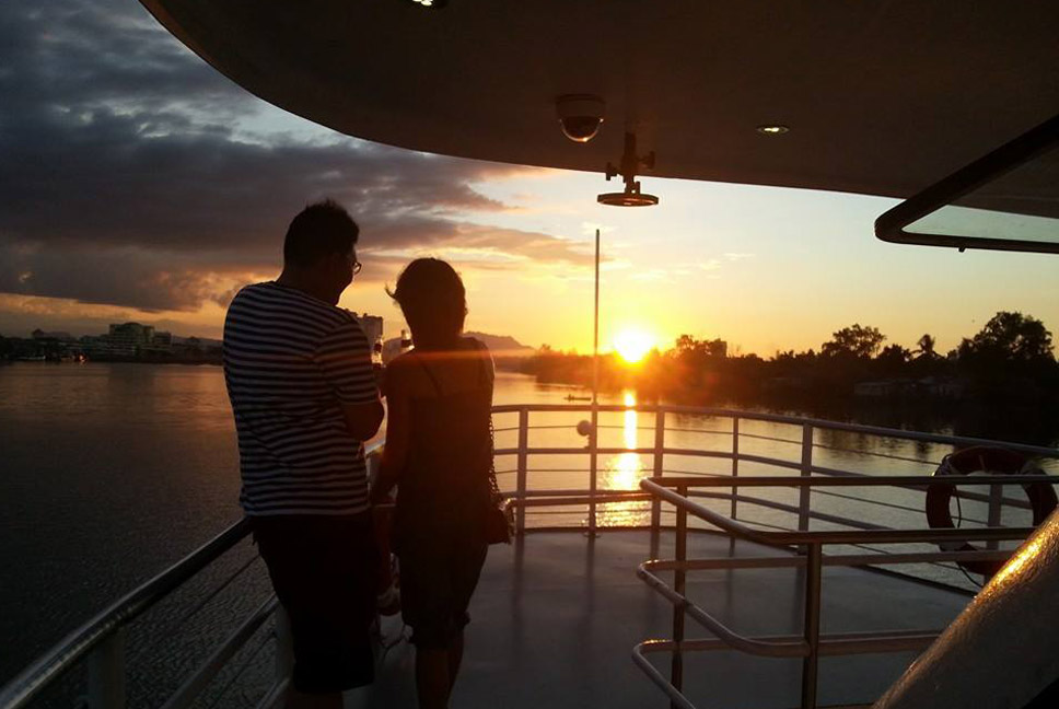 A couple enjoying the sunset view on the Sarawak River Cruise