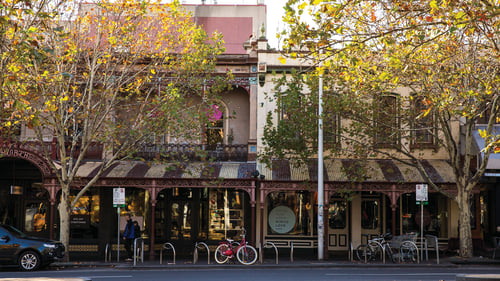 A picturesque street lined with historic buildings and vibrant autumn leaves.