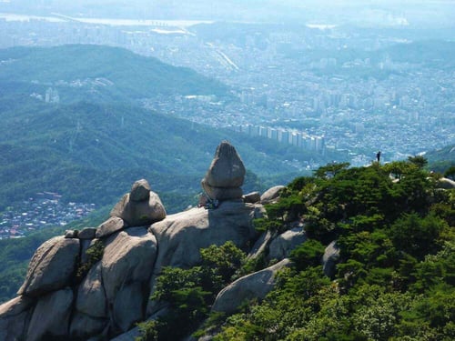 A snapshot of a scenic trail and city view from Bukhansan National Park