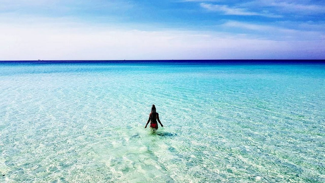 A visitor of Koh Rong Island enjoying the crystal-clear waters