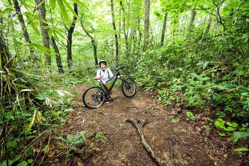 A woman with a mountain bike in Nopporo Forest