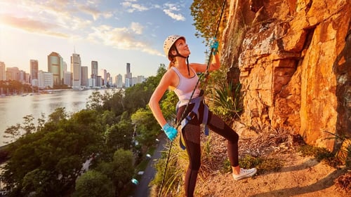 Adventurers abseiling down the sheer cliffs of Kangaroo Point