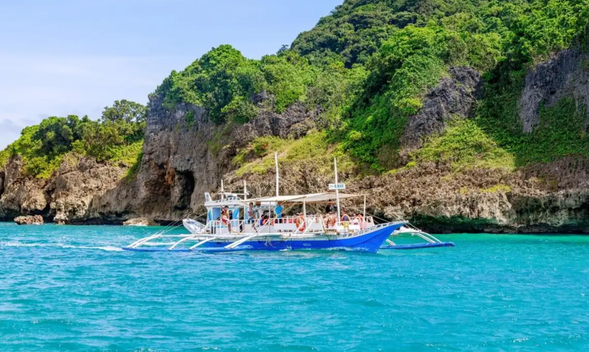 Boat stopping in Boracay for island hopping, one of the interesting activities to do