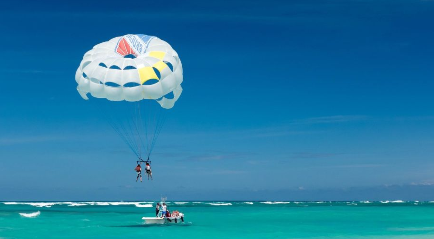 Couple doing parasailing, which is a must-do in Boracay