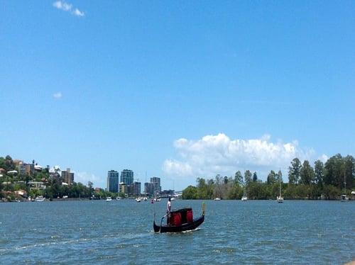 Couple enjoying a sunset dinner on a private gondola along the Brisbane River