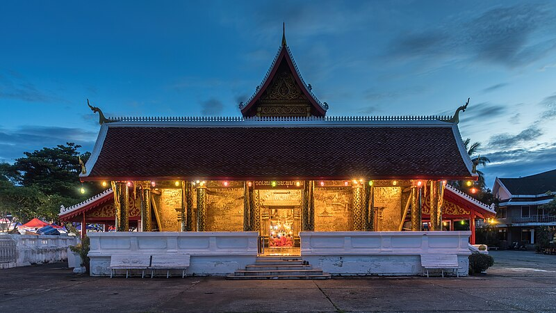 Elaborate carvings and golden details adorn the facade of Wat Xieng Thong temple in Luang Prabang