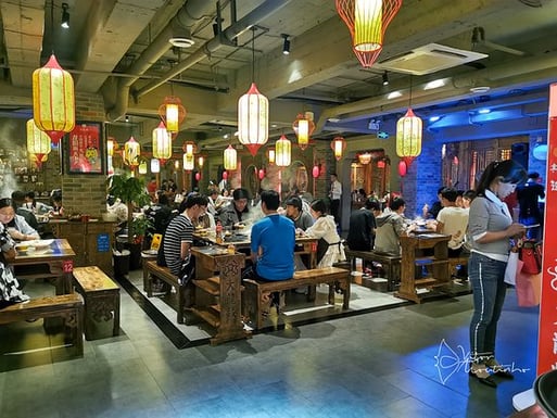 Experience the bustling atmosphere at DaLongYi Hot Pot, renowned for authentic Sichuan cuisine in Chengdu.