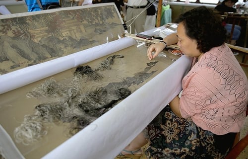 Factory worker hard at work at Suzhou Embroidery Factory