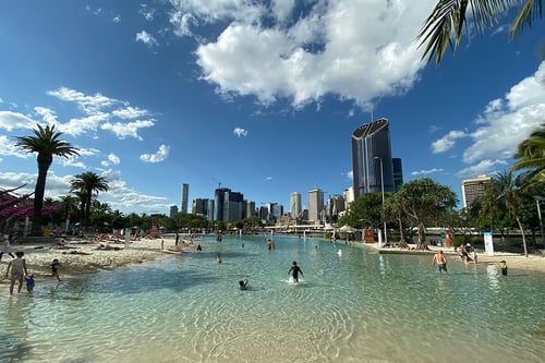 Families enjoying the sun and sand at Streets Beach, Brisbane’s inner-city man-made beach