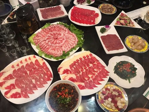 Gathering around a table full of indulgent hotpot ingredients is a must-do activity in Beijing.