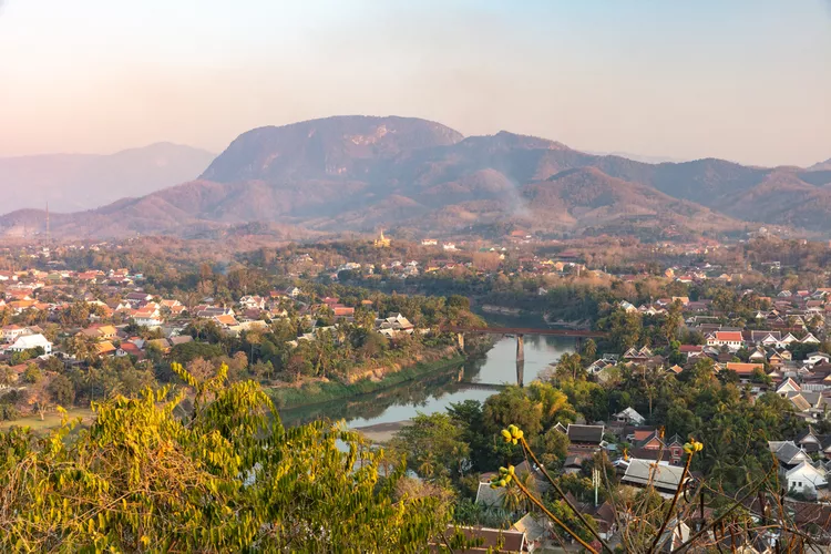 Golden temples and traditional houses of Luang Prabang at sunset