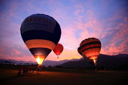 Hot air balloons setting off in Luye Highlands, Taitung against the setting sun