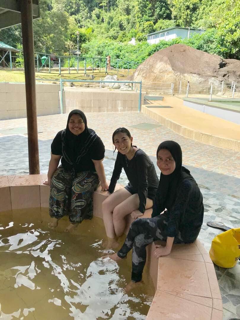 Teoh (middle) and her friends dipping their legs in the soothing hot spring. 