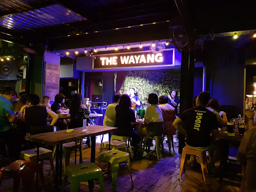 Locals and tourists tuning into the live performance at The Wayang