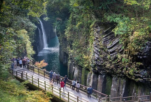 Locals and visitors taking in the scenery at Takachiho Gorge.