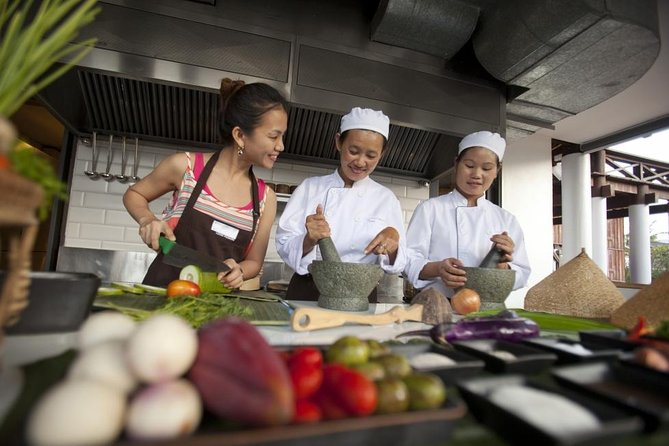 Participant learning to cook traditional Lao dishes in a cooking class