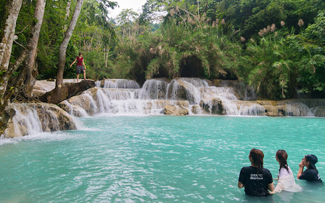 People swimming in the Tad Sae Waterfall in Luang Prabang