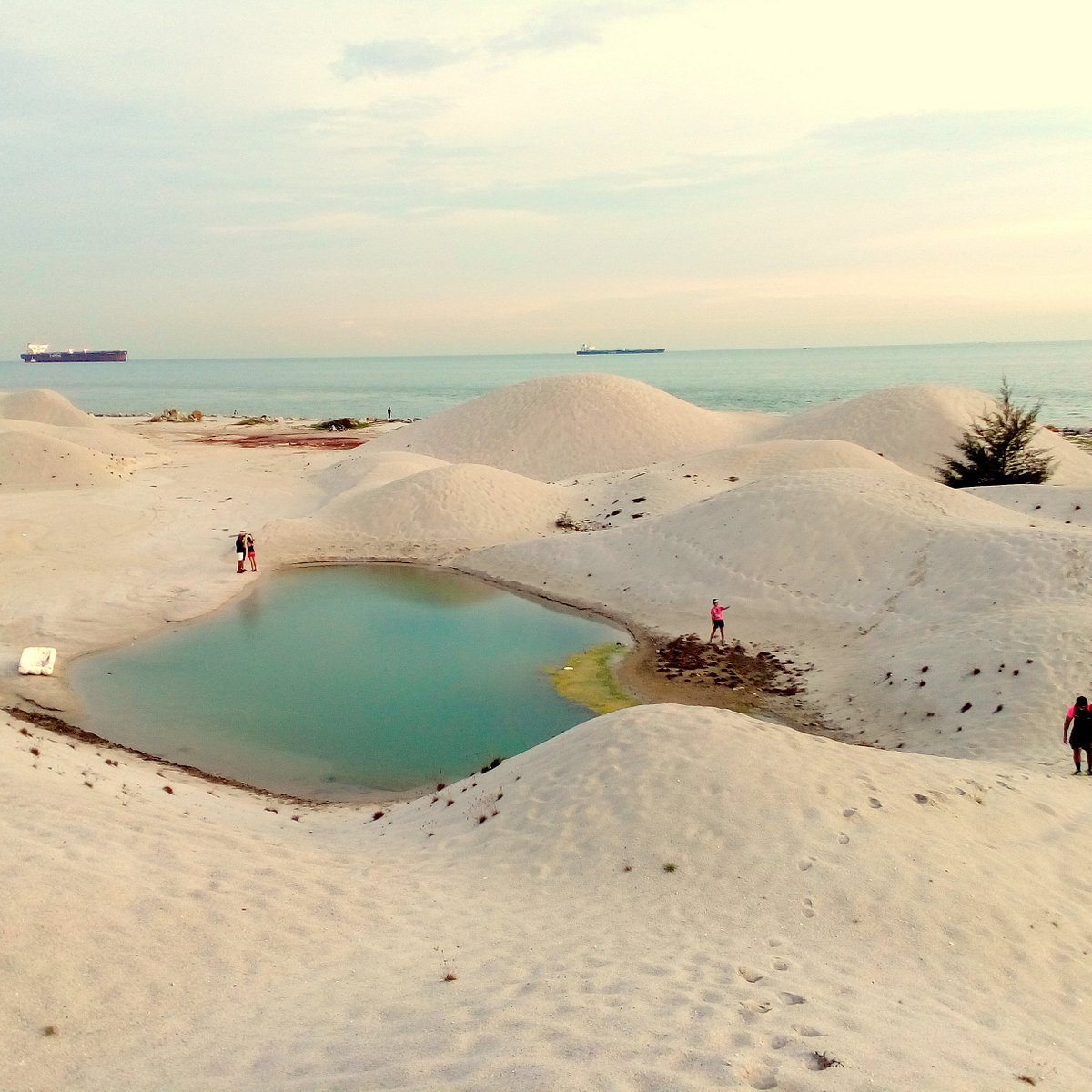 Sand dunes along the beach at Pantai Klebang, a popular tourist attraction