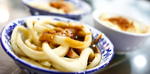 Savouring Dan Dan Noodles at Xi Yue Cheng Tan Dou Hua, showcasing the rich food culture in Chengdu.