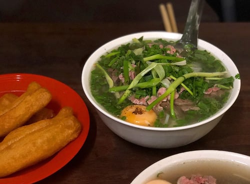 Steaming bowl of beef Pho at Pho Gia Truyen, a renowned pho spot in Hanoi