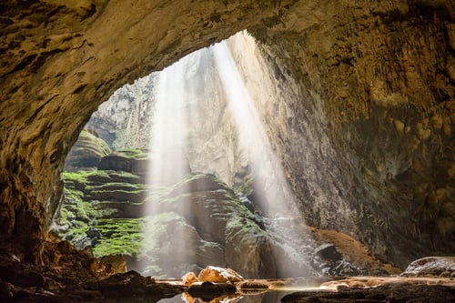 The colossal chambers of Son Doong Cave, illuminated by natural light shafts