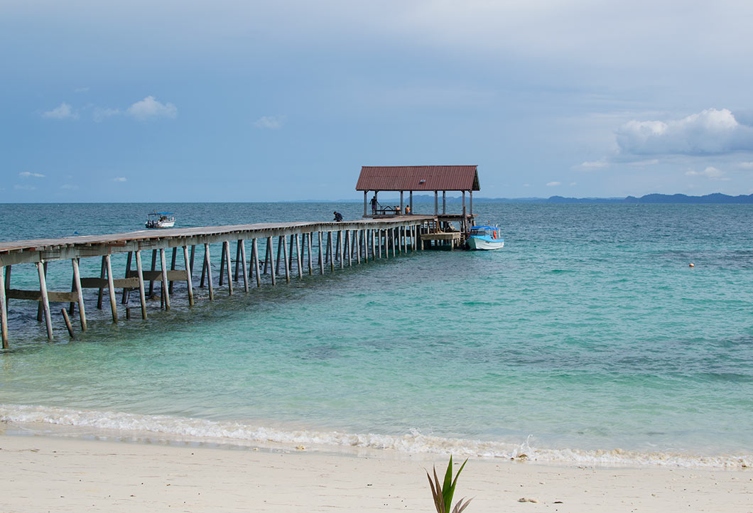 The jetty and beach at Pulau Besar, a popular attraction