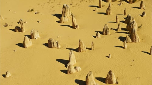 The unique rocky terrain of the Pinnacles Desert with scattered limestone formations.