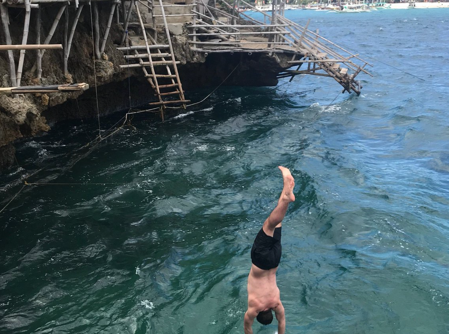 Tourist jumping off the cliff at Crocodile Island, one of the Boracay attractions