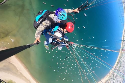 Tourist paragliding at Son Tra Peninsula with an instructor