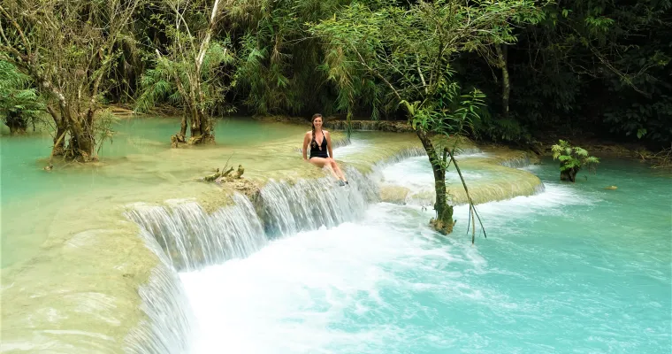 Tourist swimming in the natural pool near the Tat Kuang Si Bear Rescue Centre in Luang Prabang