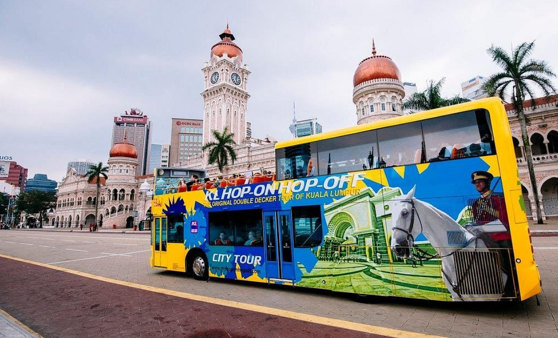Tourists aboard Hop-On Hop-Off bus to see top attractions in Kuala Lumpur