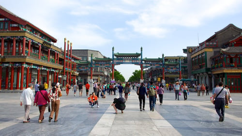 Tourists and locals walking along Qianmen Street, Beijing, a tourist attraction.