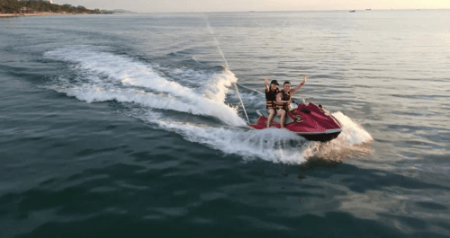 Tourists enjoying the thrill of jet skiing on the crystal-clear waters of Long Beach, a popular Phu Quoc attraction for water sports enthusiasts.