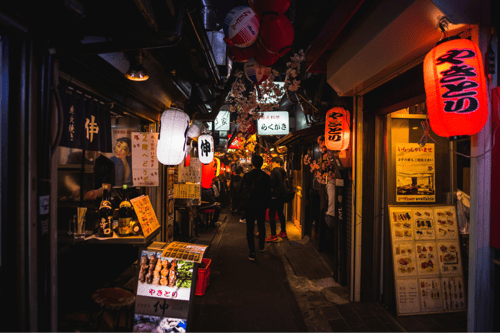 Tourists in Omoide Yokocho, Tokyo at night
