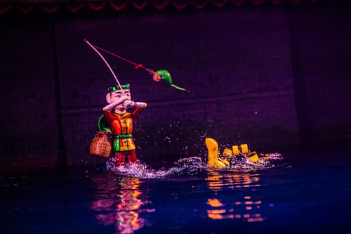 Traditional Vietnamese water puppet show in action at Thang Long Theatre