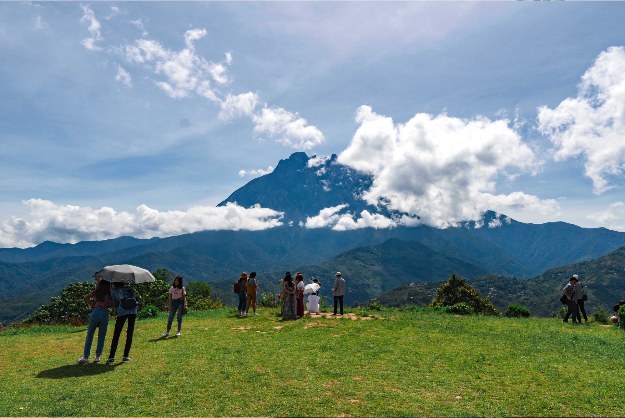 Travellers viewing Mount Kinabalu, an iconic tourist attraction in Sabah