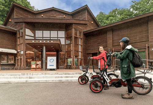 Two tourists getting bikes for their route in Hachimantai