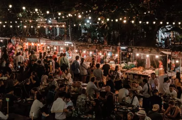 Vendors selling street food and snacks to the bustling crowd at the night market