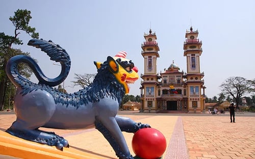 Vibrant exterior of Cao Dai Temple showcasing its colourful architectural details in Tay Ninh, Vietnam