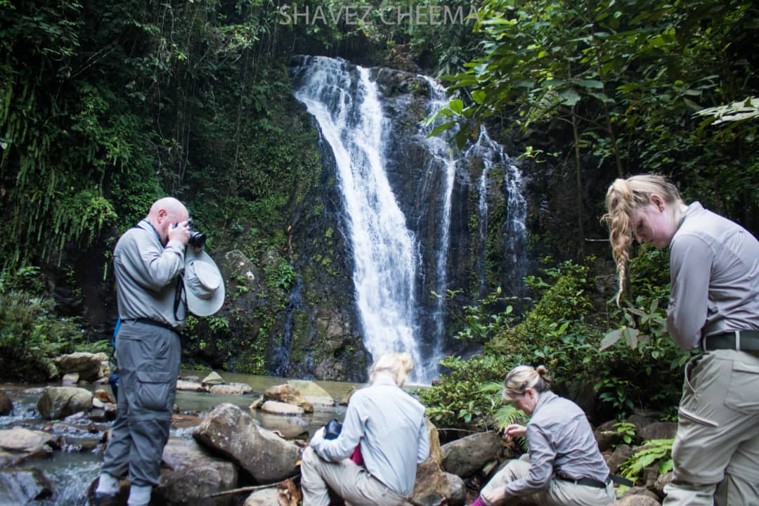 Visitors at the Tawau Hills Park waterfall, a popular attraction in Sabah