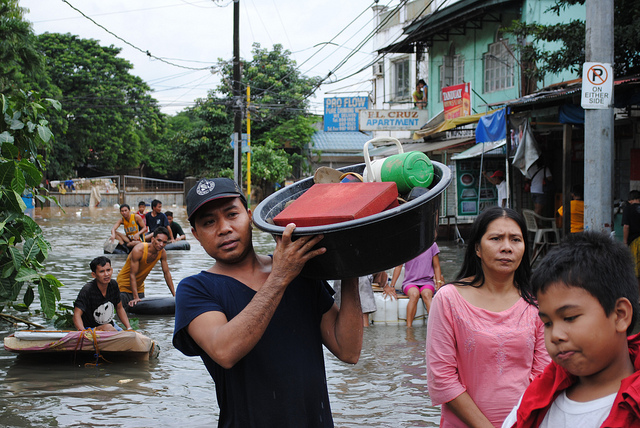 filipinos in flooded street