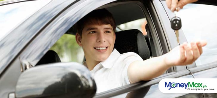 a young man riding on his car