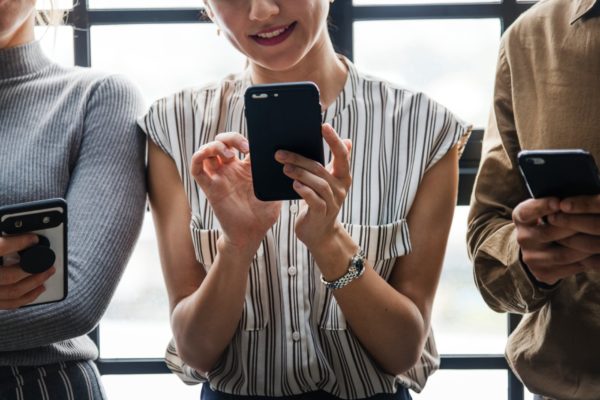 Discover Your Money Personality: The Hivemind - woman using smartphone