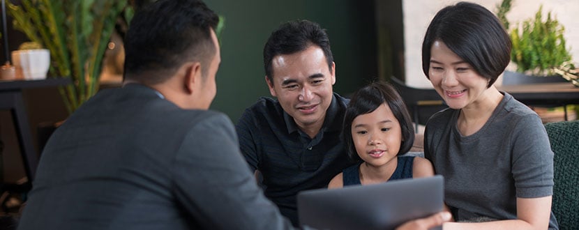 family of 3 happy looking at laptop screen information -SingSaver