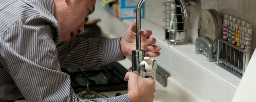 man fixing leaking pipe - SingSaver