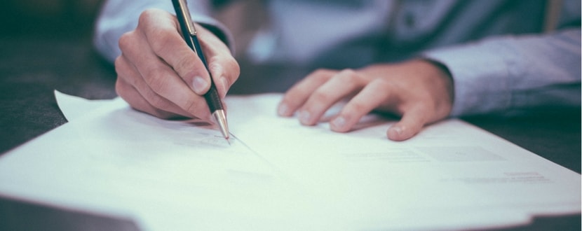 man signing insurance contract