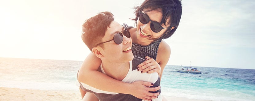 couple enjoying themselves on a beach -SingSaver