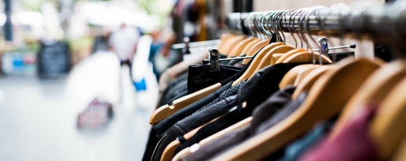 row of discount clothes in shopping mall