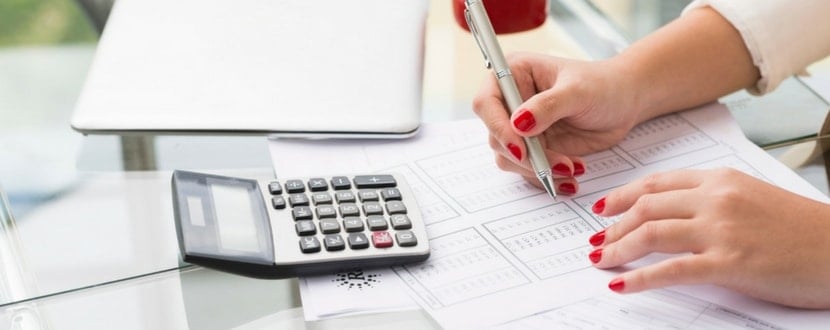 lady measuring financial statement with calculator